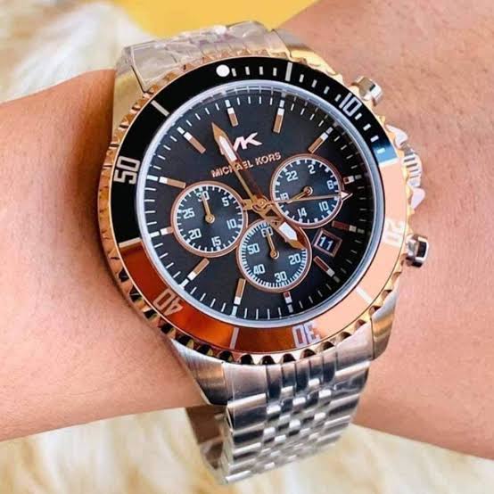 Michael Kors Men's Bayville 44x50mm watch features a black sunray dial with silver-tone stick indexes and numerals, chronograph movement and Steel bracelet.